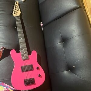 Electric Guitar, comes with a stand amp attachments 3books and a case.